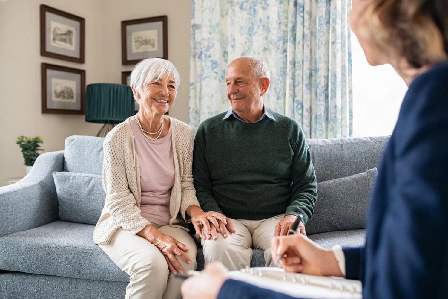 Senior couple meeting a financial advisor in the UAE to review a life insurance policy